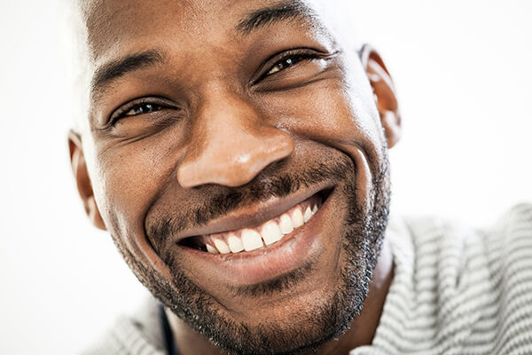 A male patient smiling after his treatment