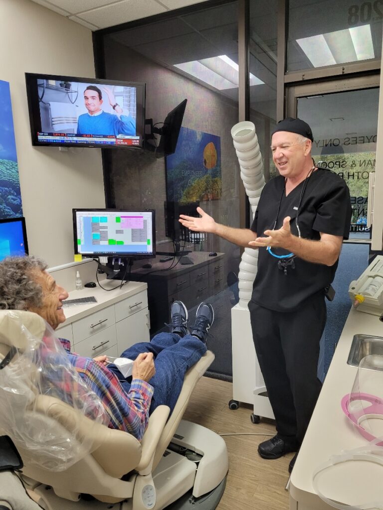 Dr. Robert Spoont is consulting a patient about root canal therapy.